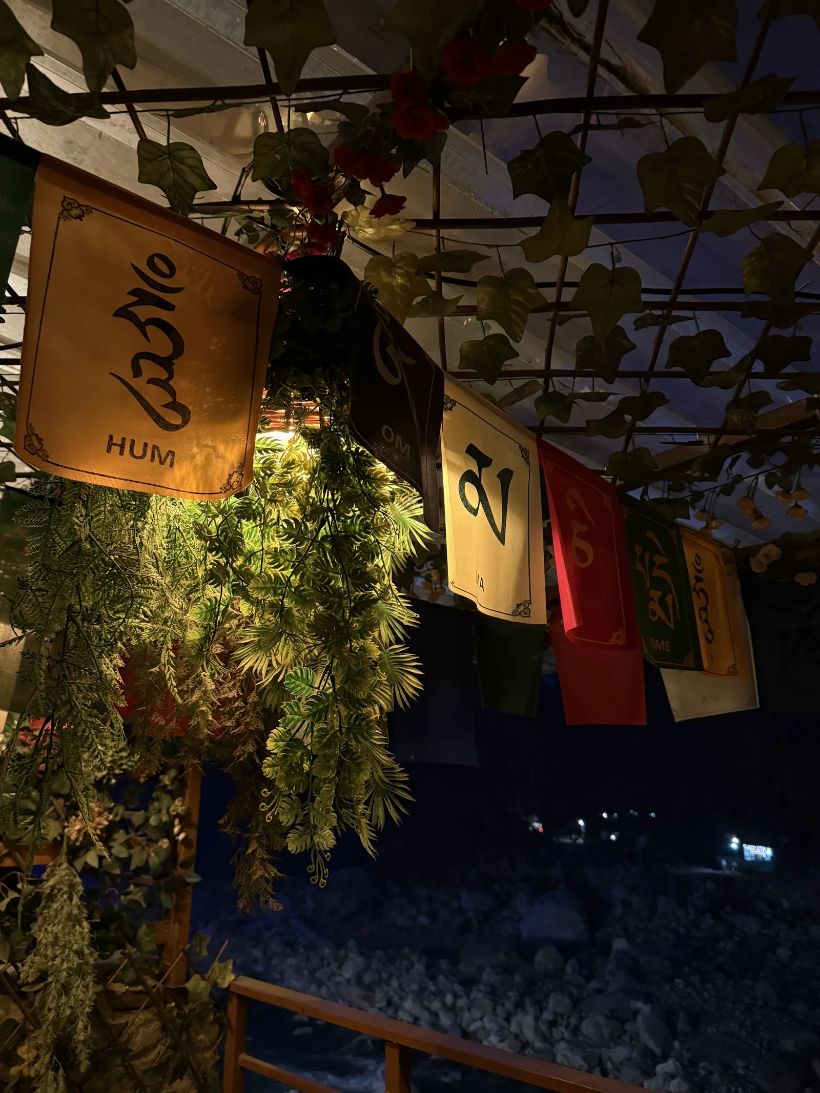 Kasol & Kheerganga: Prayer flags at a riverside cafe after dark